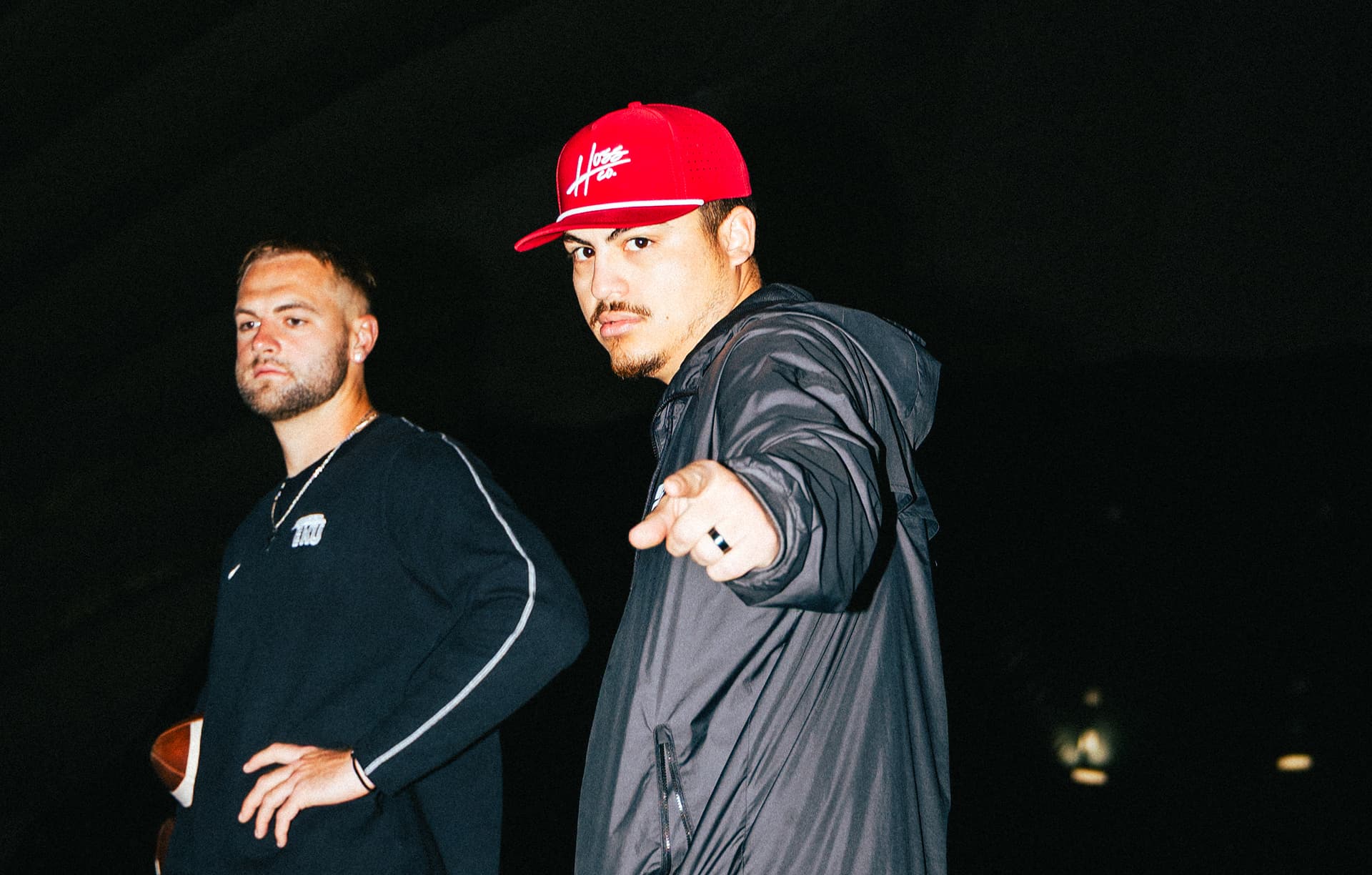 Eddie Garcia pointing to the screen at a QB Era training session with quarterback Matt Morrsisy in the background