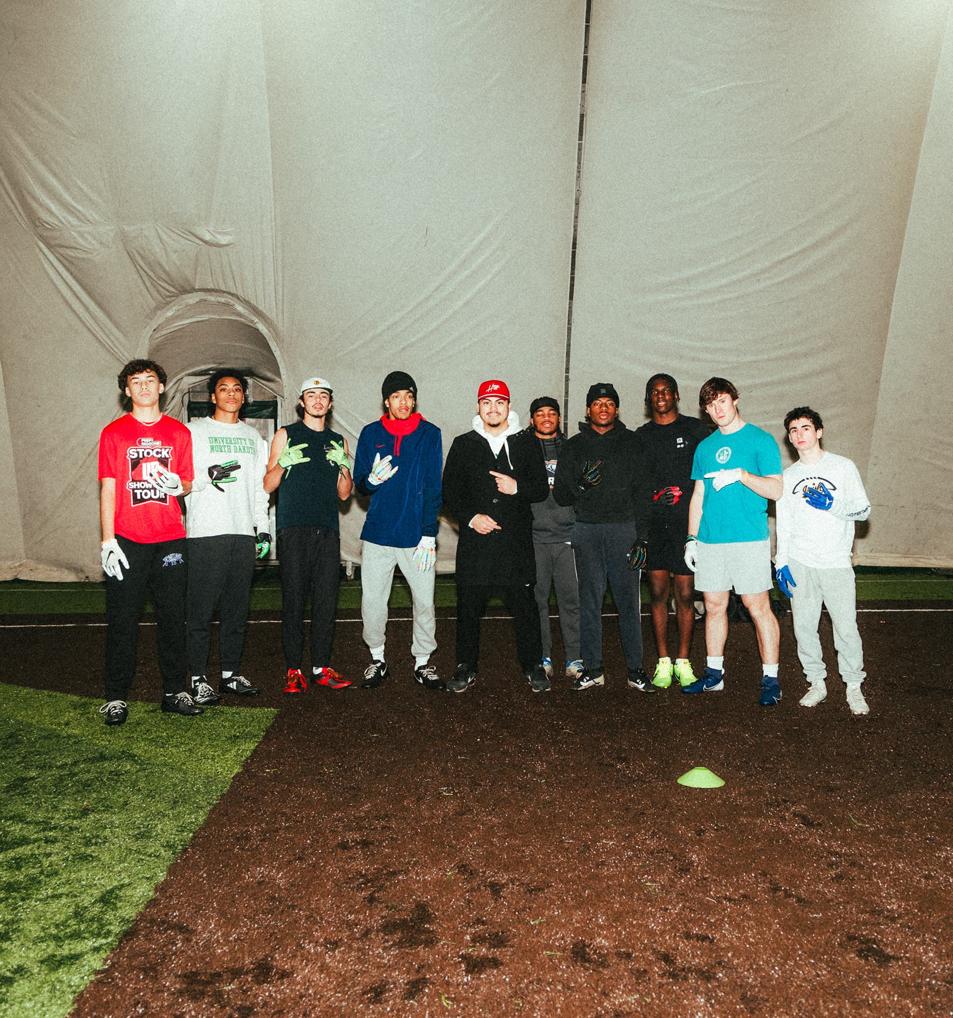 Eddie Garcia, manager and co-owner of QB Era, standing in group photo with wide receivers from a group session