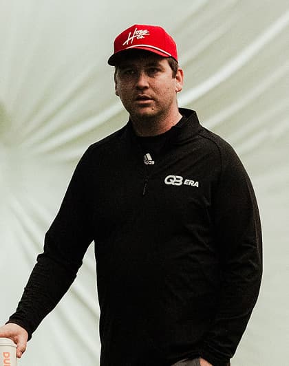 Coach Sean Anderson coaching a quarterback at a training session